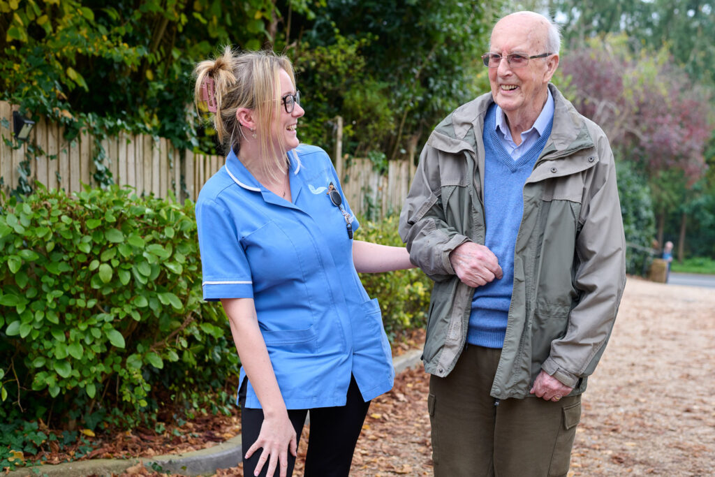 STAFF MEMBER IN CONVERSATION WITH RESIDENT